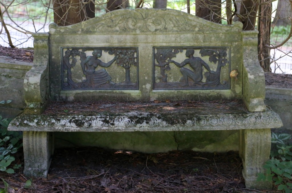 Inset with bronze plaques featuring Adam and Eve, this stone bench sold at $2,530.